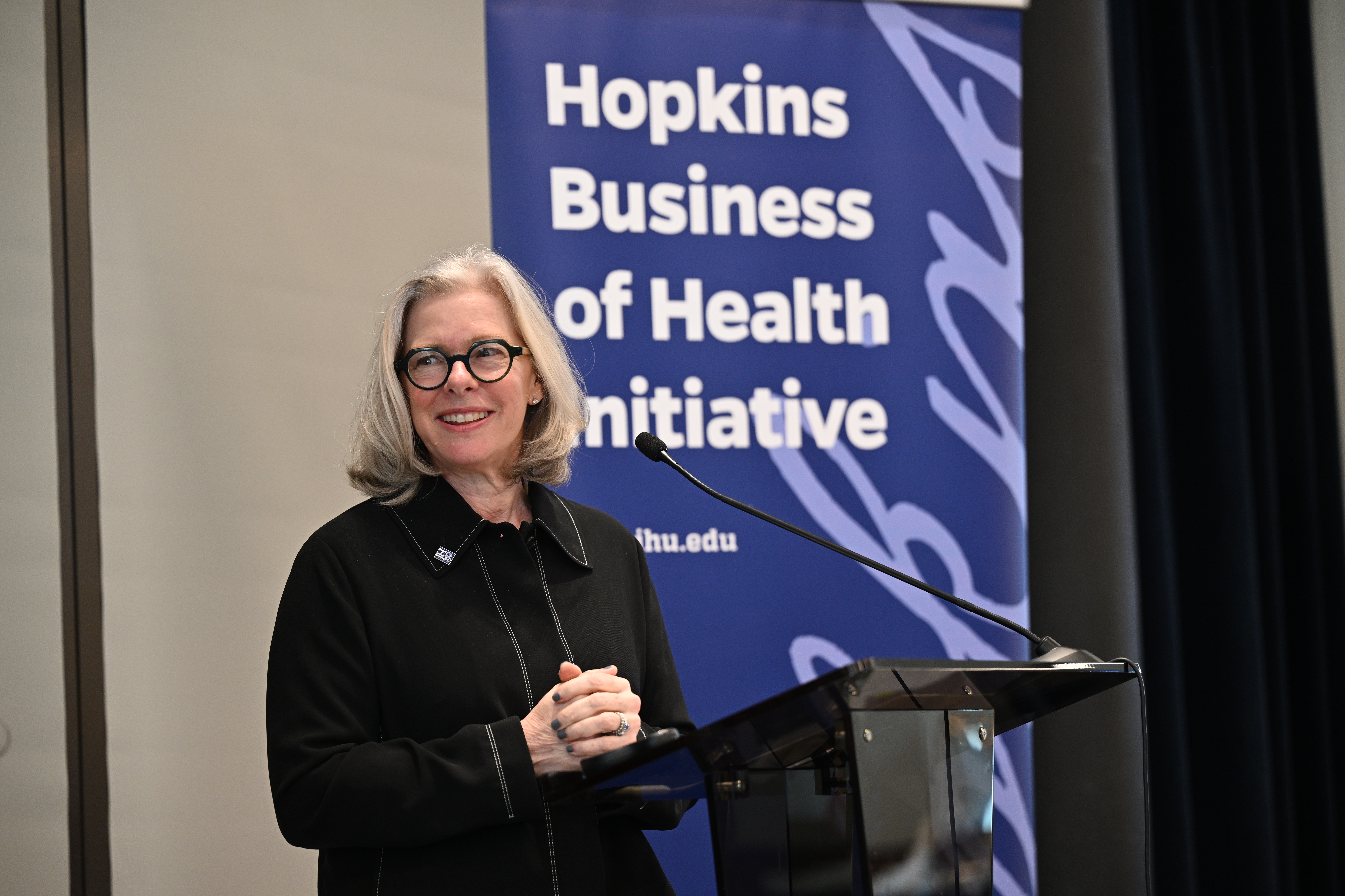Cybele Bjorklund, executive director of the Johns Hopkins University Bloomberg Center, smiling at a podium